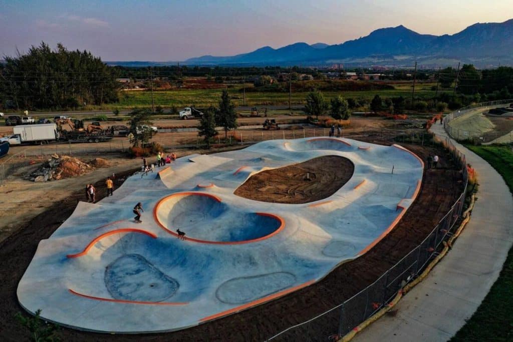 A gray skatepark against a mountain.