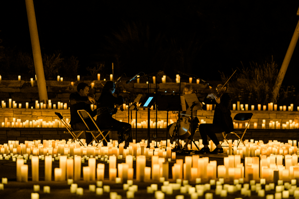 A string quartet surrounded by candlelight
