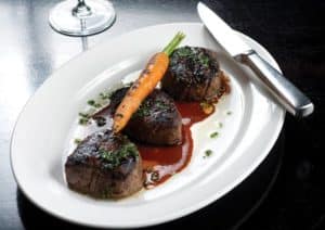 Steak cuts topped with a carrot from Guard and Grace in Denver