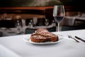 Steak and glass of wine from Ruth’s Chris Steak Housein Denver