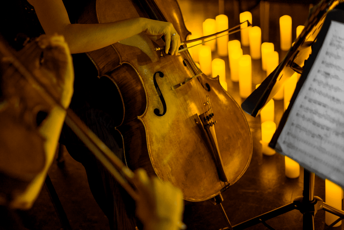 A cello being played in candlelight.