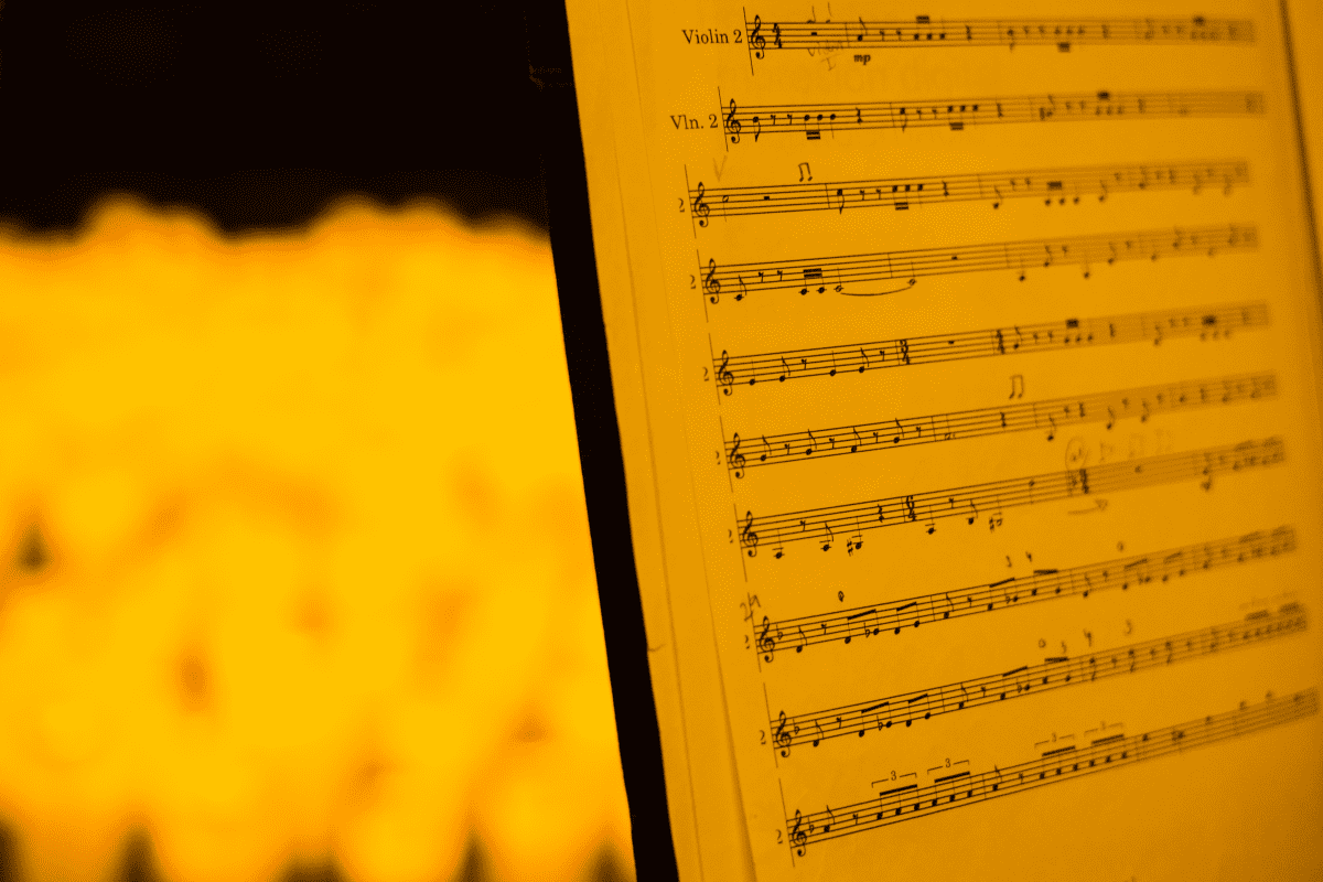 Music sheets bathed in the glow of candlelight.