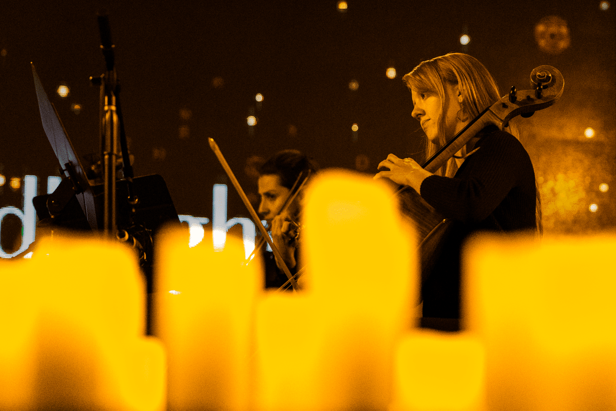 Musicians performing behind candles.